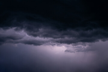 Obraz premium Menacing black clouds on the sky as a sign of coming storm. Concept of weather, rain shower, power and beauty of nature