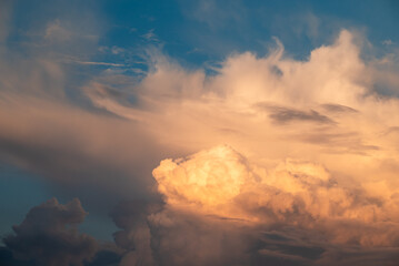 Beautiful white clouds lighten with sun rays on the blue sky. Big clouds floating in the sky,...