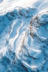 Snowy mountain slopes with rocky outcrops