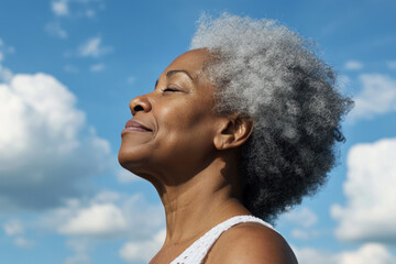 Afro senior woman taking a breath on a sunny day, mental health