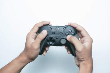 Hand holding a gamepad or joystick against a white background with empty copy space for text or advertisement