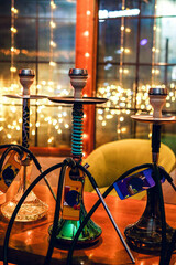 Shisha bar lounge in smoke with spotlights in the night dark blue colors