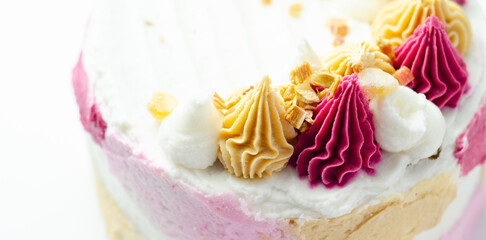 A cake with pink frosting and white frosting with a pink swirl on top