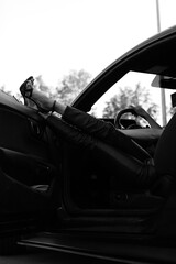 woman's legs with shoes by the way the supercar window on vacation. Concept of happiness and fun during the trip in the summer