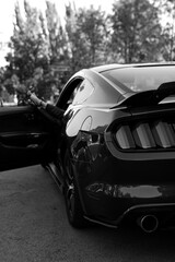 woman's legs with shoes by the way the supercar window on vacation. Concept of happiness and fun during the trip in the summer