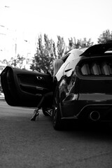 woman's legs with shoes by the way the supercar window on vacation. Concept of happiness and fun during the trip in the summer
