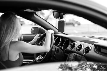 Young woman driver hands close up hold steering wheel car.
