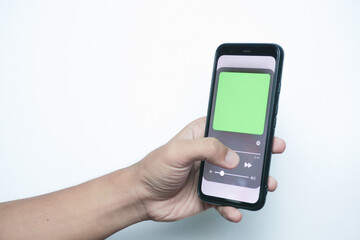 Hand holding a smart phone which displays a media player app