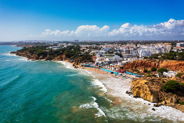 Fototapeta premium Amazing view from the sky of town Olhos de Agua in Albufeira, Algarve, Portugal. Aerial coastal view of town Olhos de Agua, Albufeira area, Algarve, Portugal.