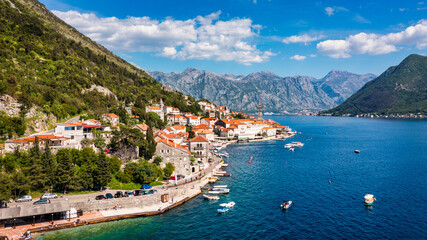 View of the historic town of Perast at famous Bay of Kotor on a beautiful sunny day with blue sky and clouds in summer, Montenegro. Historic city of Perast at Bay of Kotor in summer, Montenegro.