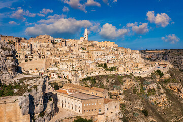 Obraz premium Panoramic view of the ancient town of Matera (Sassi di Matera) in a beautiful autumn day, Basilicata, southern Italy. Stunning view of the village of Matera. Matera is a city on a rocky outcrop.
