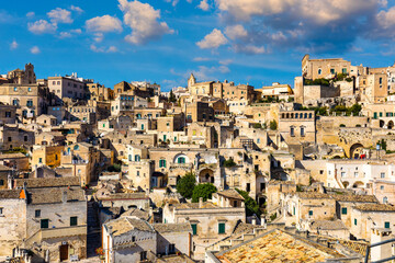 Obraz premium Panoramic view of the ancient town of Matera (Sassi di Matera) in a beautiful autumn day, Basilicata, southern Italy. Stunning view of the village of Matera. Matera is a city on a rocky outcrop.