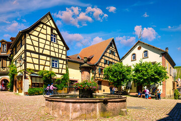 Riquewihr, France - July 2, 2022: Riquewihr village on Alsatian Wine Route, France. Most beautiful villages of France, Riquewihr in Alsace, famous "vine rote". Colorful town of Riquewihr, France.