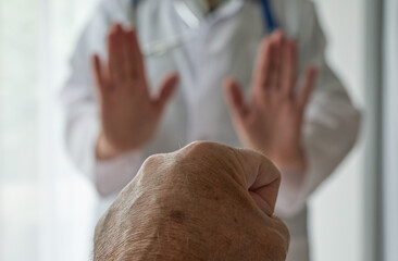 Medical staff abuse. Threatening behaviour towards a doctor, Physician. Angry and violent patient. Zero tolerance.  