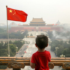 A young boy is standing on a balcony overlooking a large building with a red Chinese flag