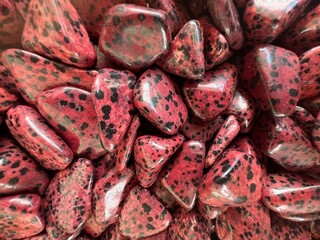 Red Dalmatian Jasper stones close up photograph 