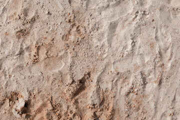 Background of beige, brown beach sand with natural pattern background. top view, flat lay