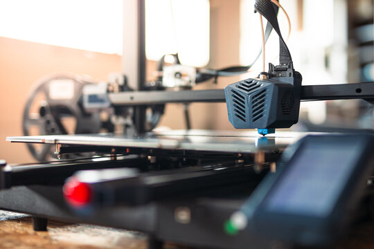 Close-up of a 3D printer at work, focusing on the print head and the detail being created. 3D printing technology in modern manufacturing and prototyping.