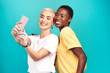 Naklejka premium Women, happy and diversity with selfie, together and bonding in studio background for friendship. Female people, pride and smile as cheerful for international womens day, celebration and social media