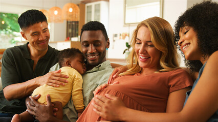 Group of Friends Enjoys Quality Time Together With Newborn and Expectant Mother in Cozy Living Room