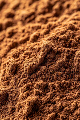 Macro shot of the texture of ground cinnamon showcasing the fine reddish brown powder with a velvety appearance 