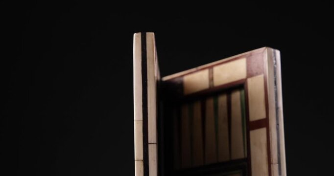 Detailaufnahme Rotation eines Backgammon und Schach Spielbretts vor schwarzem Hintergrund
