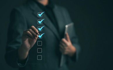 Business performance checklist concept Young business woman using laptop surveys online checklist...