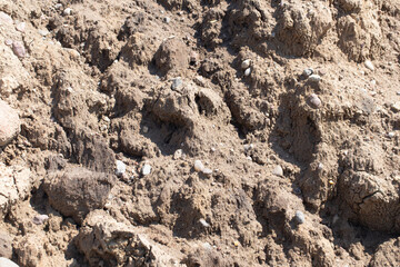 Pile of sand with stones. Construction site texture. Building materials combining sand and rocks....