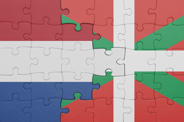 puzzle with the colourful national flag of basque country and flag of netherlands.