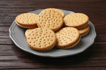 Tasty sandwich cookies on wooden table, closeup