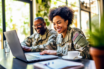 Female African American veteran in uniform uses laptop to search for jobs online in bright, modern workspace. Concept of veterans seeking employment and social reintegration through online job search