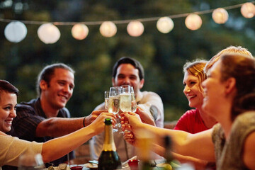 Hands, laughing and toast with friends outdoor in garden of home for celebration or social gathering together. Champagne, cheers and funny with group of people in backyard for bonding or milestone