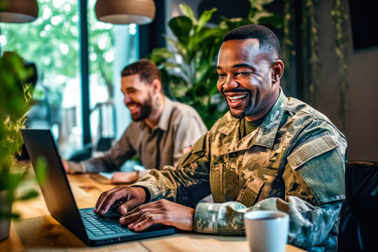A male African American veteran in uniform is searching for jobs online using a laptop in a modern cafe. Concept of veterans seeking employment and social reintegration through online job search