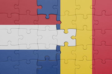 puzzle with the colourful national flag of romania and flag of netherlands.