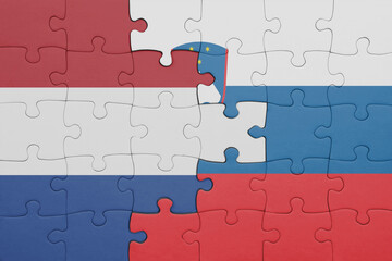 puzzle with the colourful national flag of slovenia and flag of netherlands.