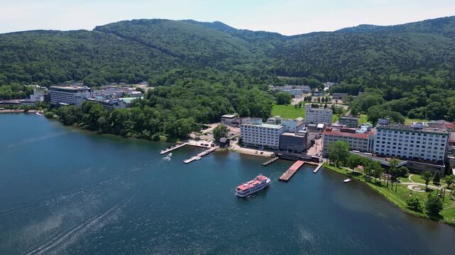 Lake Akan, Japan: Aerial drone footage of the Akano Onsen resort town by lake Akan in the Akan-Mashu National Park in Hokkaido in summer in Japan. 