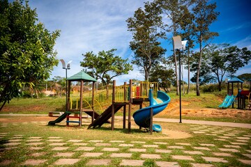 Colorful playground with slides and climbing structures in a park on a sunny day. Brazil
