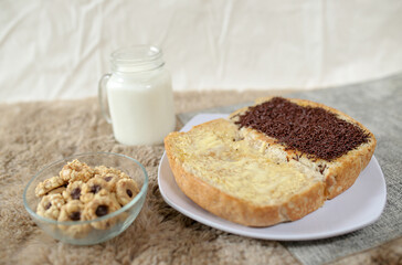 Bread with chocolate choco rice and butter with milk and snack for breakfast	
