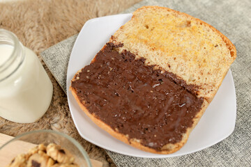 Bread with chocolate spread filling, milk and snack for breakfast	
