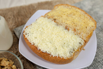 Bread with cheese, sweetened condensed milk, and butter. With white milk and snack on a table for breakfast	
