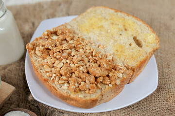 Bread with peanut and butter spread on a table for breakfast	
