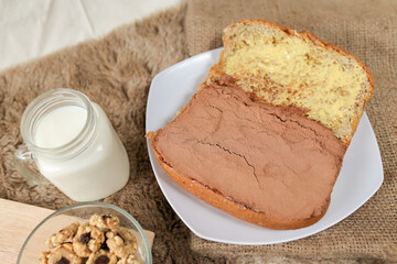 Bread with choco powder and butter on a plate for breakfast	
