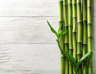 Fototapeta premium Tranquil Green Bamboo Stalks on White Wooden Background Top View Natures Serenity