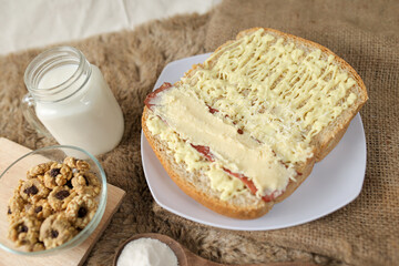 Bread with smoked beef and mozarella cheese on a plate for fast food breakfast or coffee break.	
