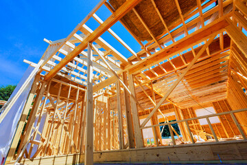 In construction site, new home building framing with wooden trusses, post beams framework