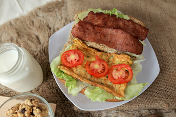 Big breakfast, bread, chicken slice, tomato, lettuce, smoked beef, egg, salad with milk. Bread sandwich fresh and healthy food meal lunch dinner breakfast slices of sandwiches.