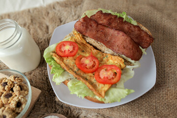 Big breakfast, bread, chicken slice, tomato, lettuce, smoked beef, egg, salad with milk. Bread sandwich fresh and healthy food meal lunch dinner breakfast slices of sandwiches.