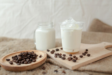 Delicious iced coffee, mocca, and chocolate drinks with coffee beans on white wooden table