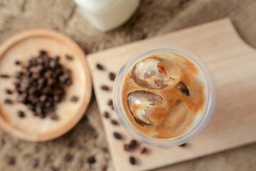 Delicious iced coffee, mocca, and chocolate drinks with coffee beans on white wooden table