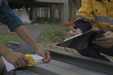 Professional architect engineer with hard hat and blueprint at building construction site house building permit background. Architects looking at blueprints. Construction and engineering industry